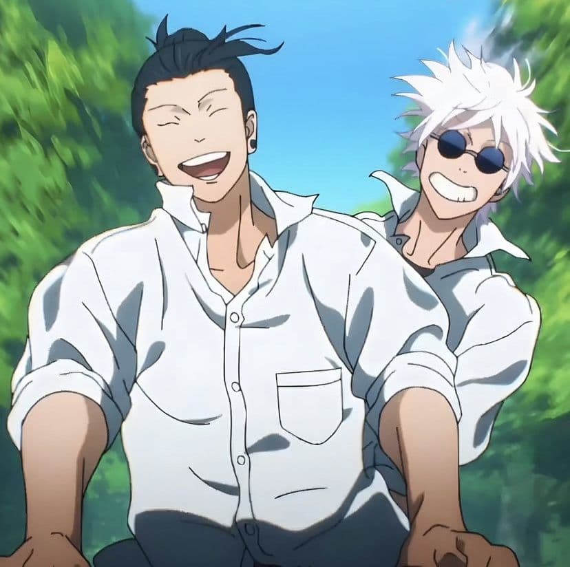 The image features two young men, Suguru Geto and Satoru Gojo, sharing a moment of intense joy and laughter. Both characters are dressed in modest, white button-down school shirts with collars slightly upturned, suggesting a casual and relaxed student life. They appear to be in motion, possibly riding a vehicle or running, with their hair windswept and expressions wide with genuine happiness. The background is a lush, vibrant green blur of foliage under a bright blue sky, indicating a natural outdoor setting. The artistic style is characteristic of modern high-budget TV anime, utilizing clean line work and sharp cel-shading to define the characters against the soft-focus environment. The overall atmosphere is one of youthful nostalgia, friendship, and pure, unburdened peace.