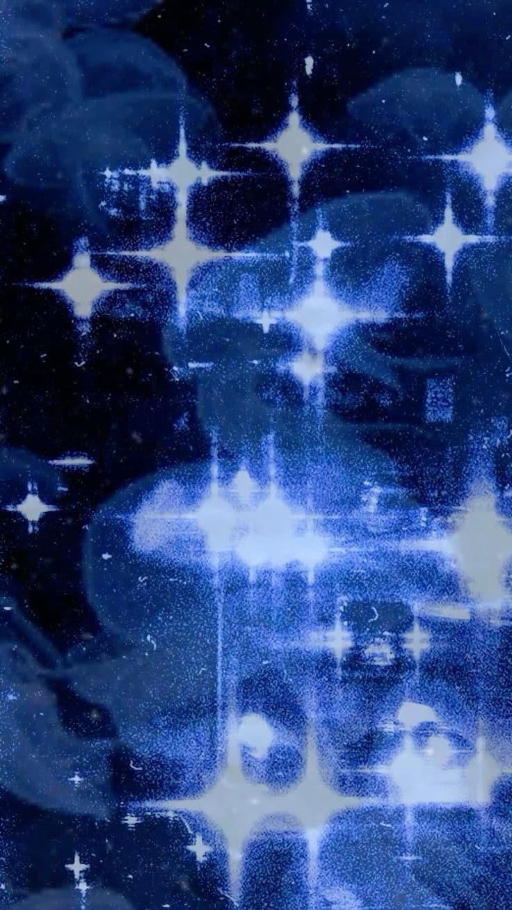 This abstract digital artwork features a mesmerizing pattern of glowing, star-like light bursts set against a deep indigo and navy blue background. The composition is layered with translucent, ghostly cloud-like forms that appear to float and dissolve into the luminous starfields. The visual effect is reminiscent of a cosmic or dreamlike atmosphere, with the stars rendered in a stylized, geometric manner, emitting bright white and cyan radiance. The overall aesthetic is ethereal and tranquil, evoking a sense of wonder and quiet contemplation through its soft gradients and repeating motifs. The image is rich in texture, with a subtle grain and overlay effects that suggest a vintage photographic or cyanotype process, enhancing its nostalgic and otherworldly appeal.