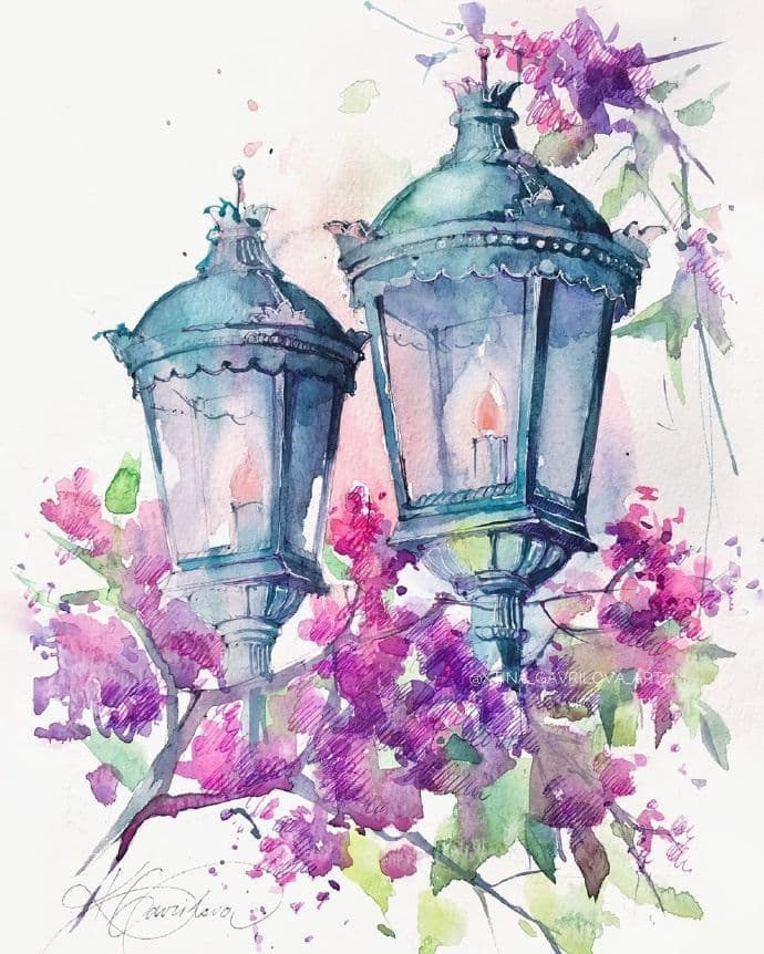This watercolor artwork depicts two ornate, vintage-style street lanterns with glowing candles inside, rendered in cool blue and teal tones. They are positioned against a backdrop of vibrant, blooming purple and pink flowers with green leaves, creating a romantic, garden-like atmosphere. The artistic style features soft, blended washes and visible brushstrokes, with delicate ink outlines defining the lanterns' intricate metalwork. The composition is balanced, with the lanterns as the central focus, surrounded by the organic, flowing forms of the blossoms. The overall mood is serene and nostalgic, evoking a quiet, peaceful evening in a blossoming urban or park setting.